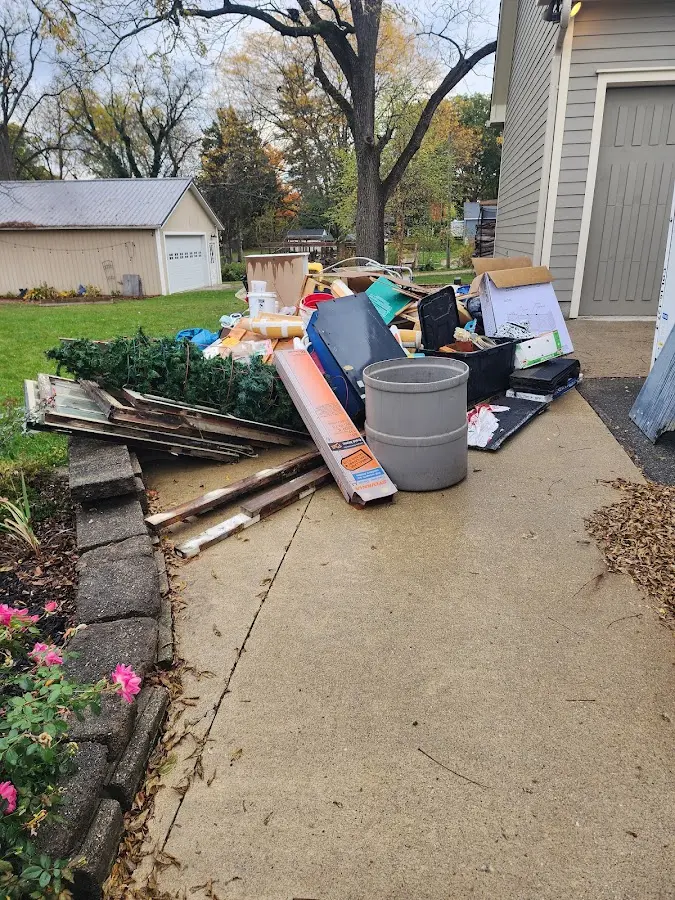 Dumpster being loaded with debris for Estate Cleanout Dumpster Rental in Vadnais Heights